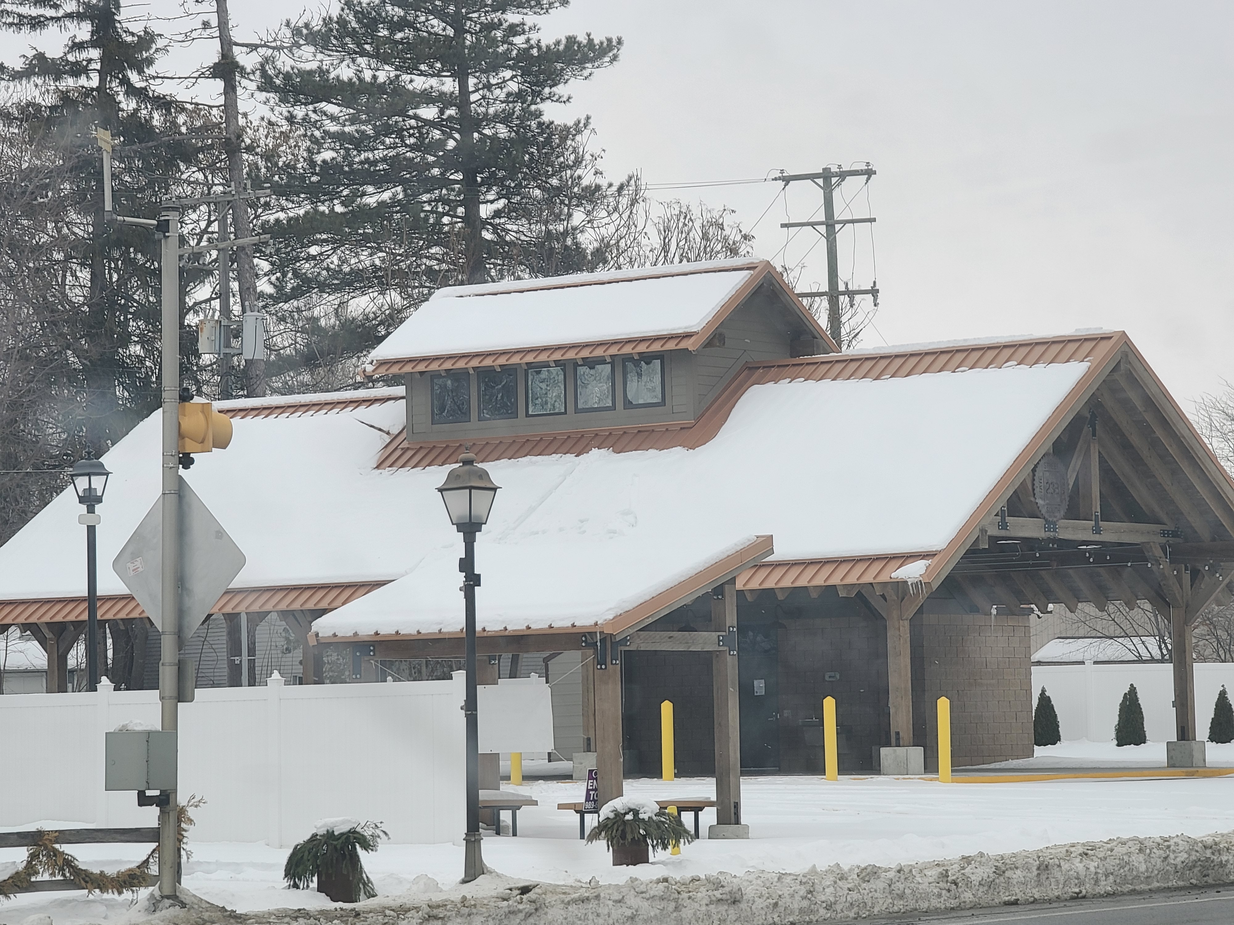 brick building with metal roof covered in snow